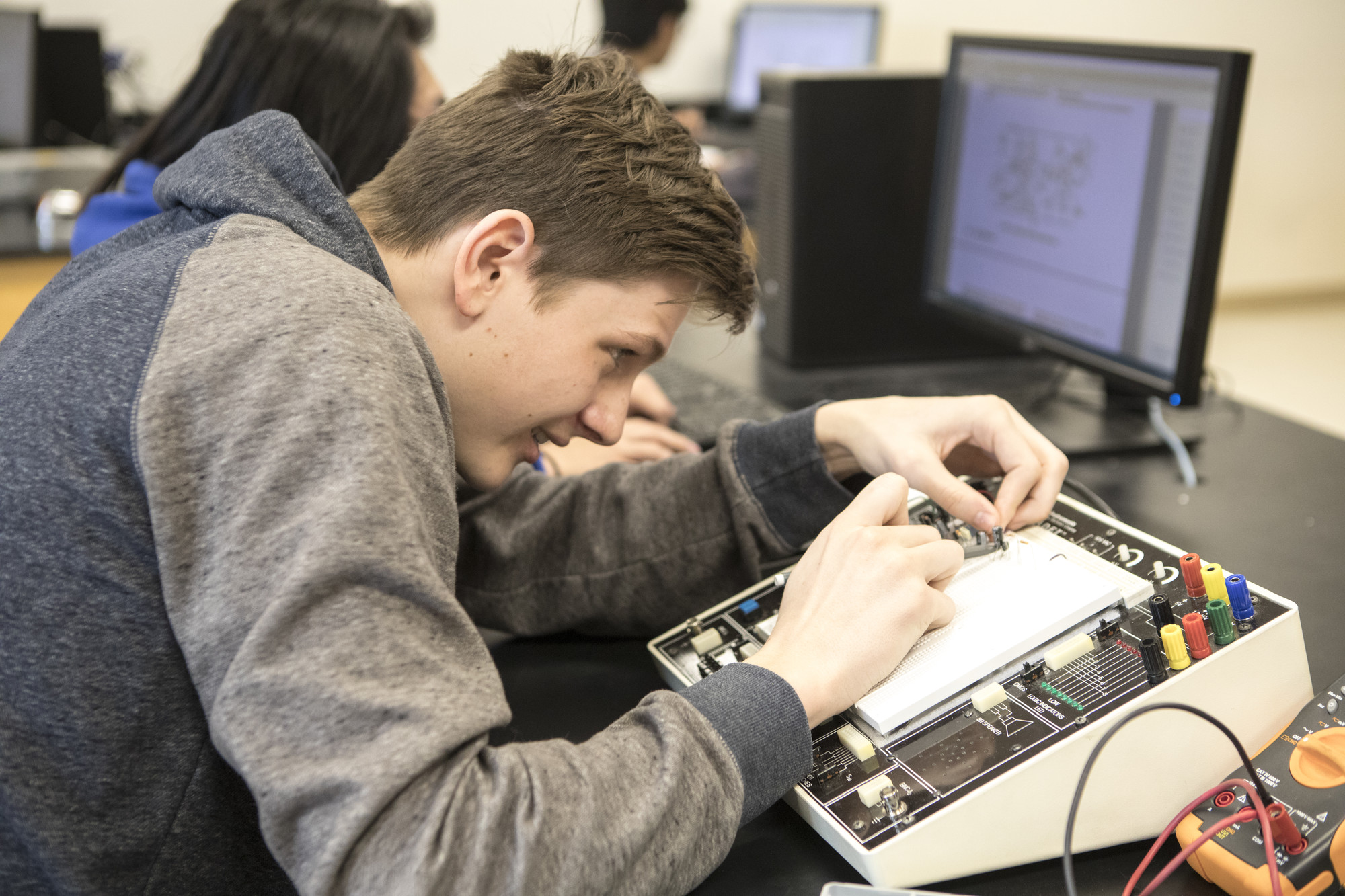 TRU student in class working with technology.