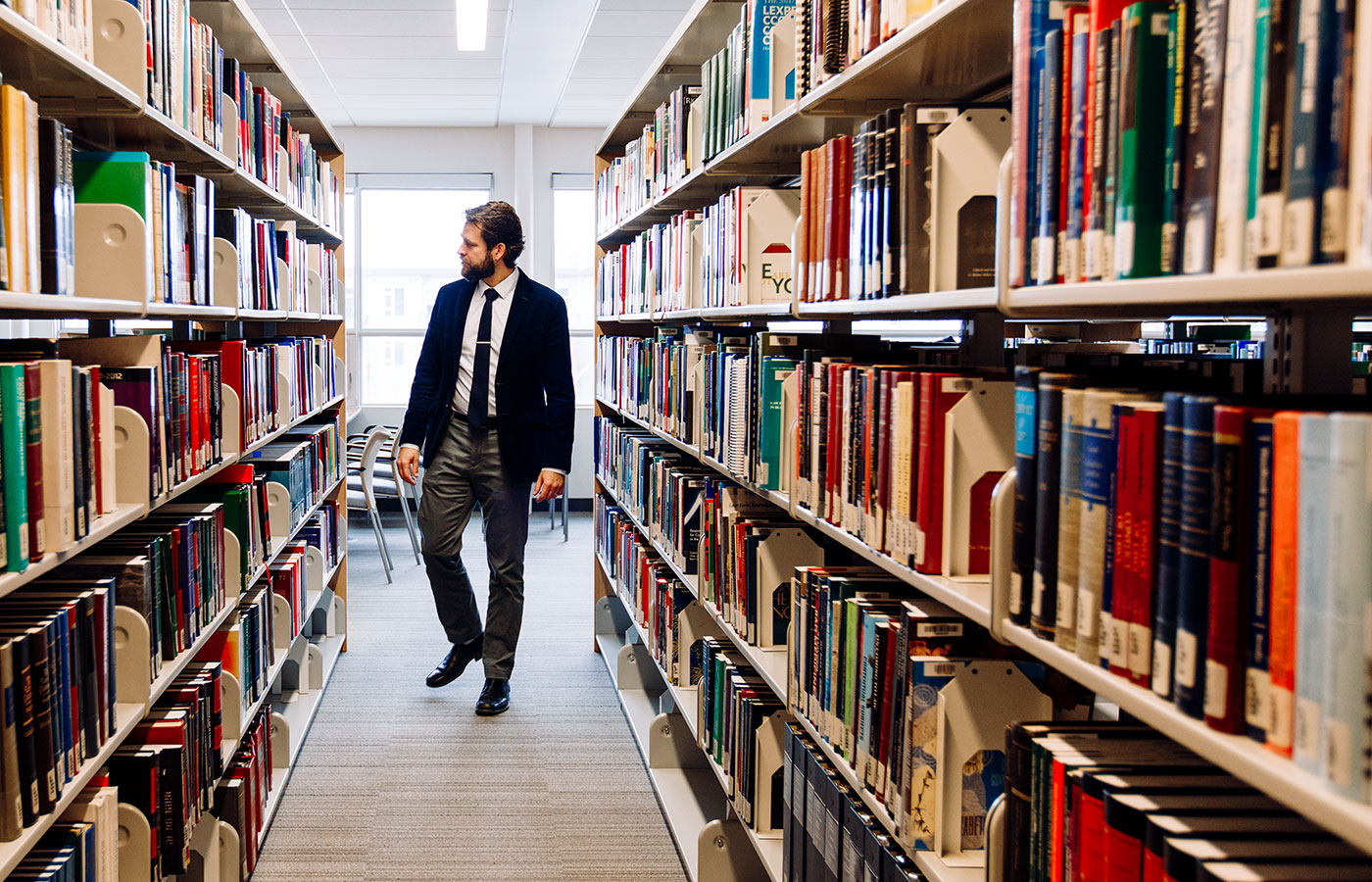 TRU Law student in library.